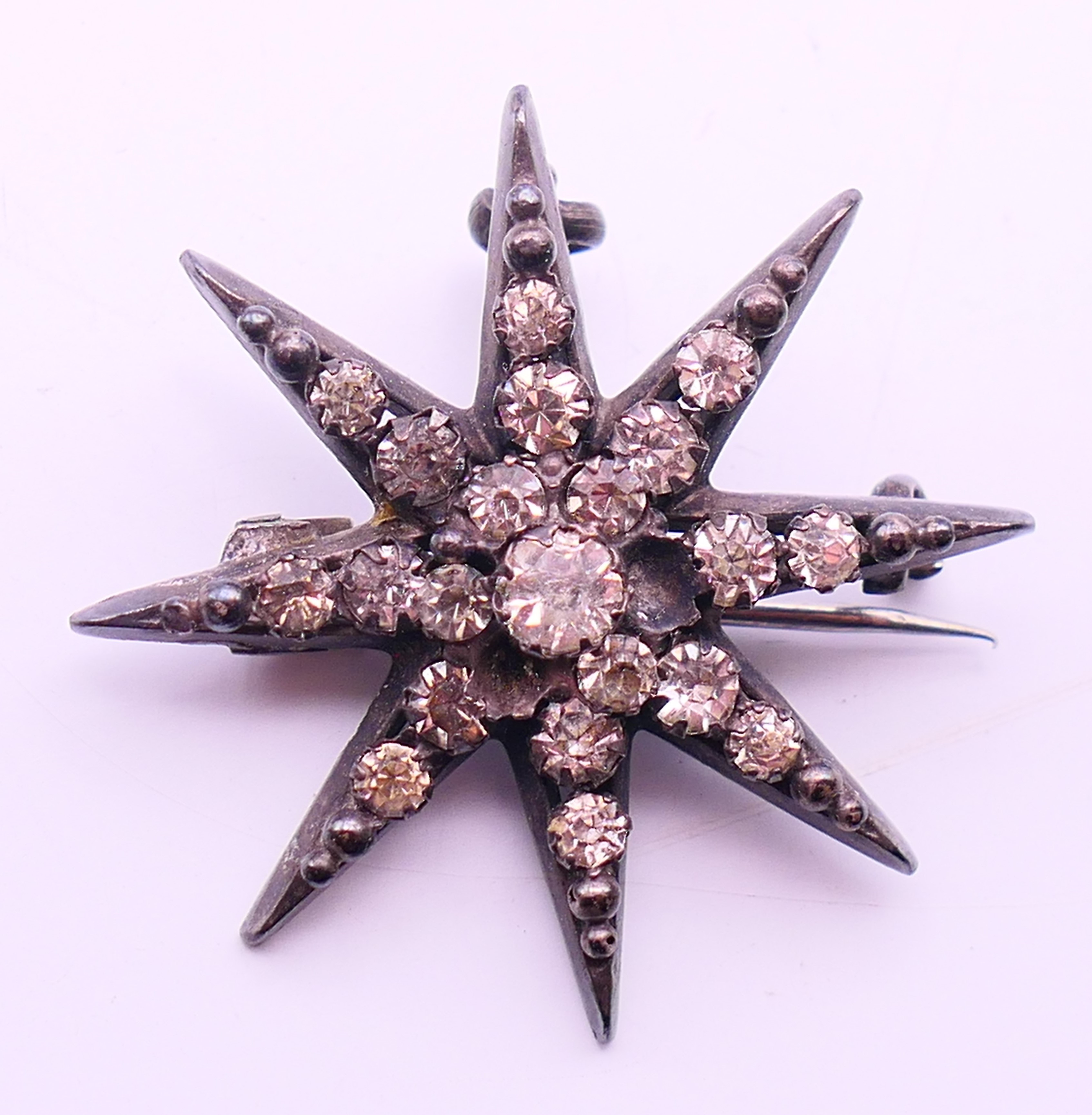 A small quantity of costume jewellery to include two necklaces and a star form brooch. Brooch 3. - Image 6 of 11