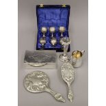 A small quantity of silver plate, including a cigarette box, a Christening mug, a brush and mirror,