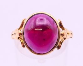 An antique unmarked 18 ct gold cabochon garnet ring. 4.5 grammes Ring size O.