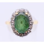An 18 ct gold and oval tourmaline and diamond cluster ring, the tourmaline (11.3 x 7.8 x 4.