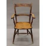 A 19th century elm seated open armchair. 56 cm wide.