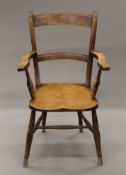 A 19th century elm seated open armchair. 56 cm wide.