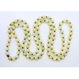 A string of celadon jade beads. 124 cm long.