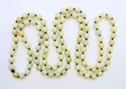 A string of celadon jade beads. 124 cm long.
