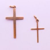 Two 9 ct gold crosses. Largest 3 cm high. 2 grammes.