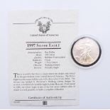 A 1997 USA 1 ounce fine silver one dollar coin with certificate of authenticity.