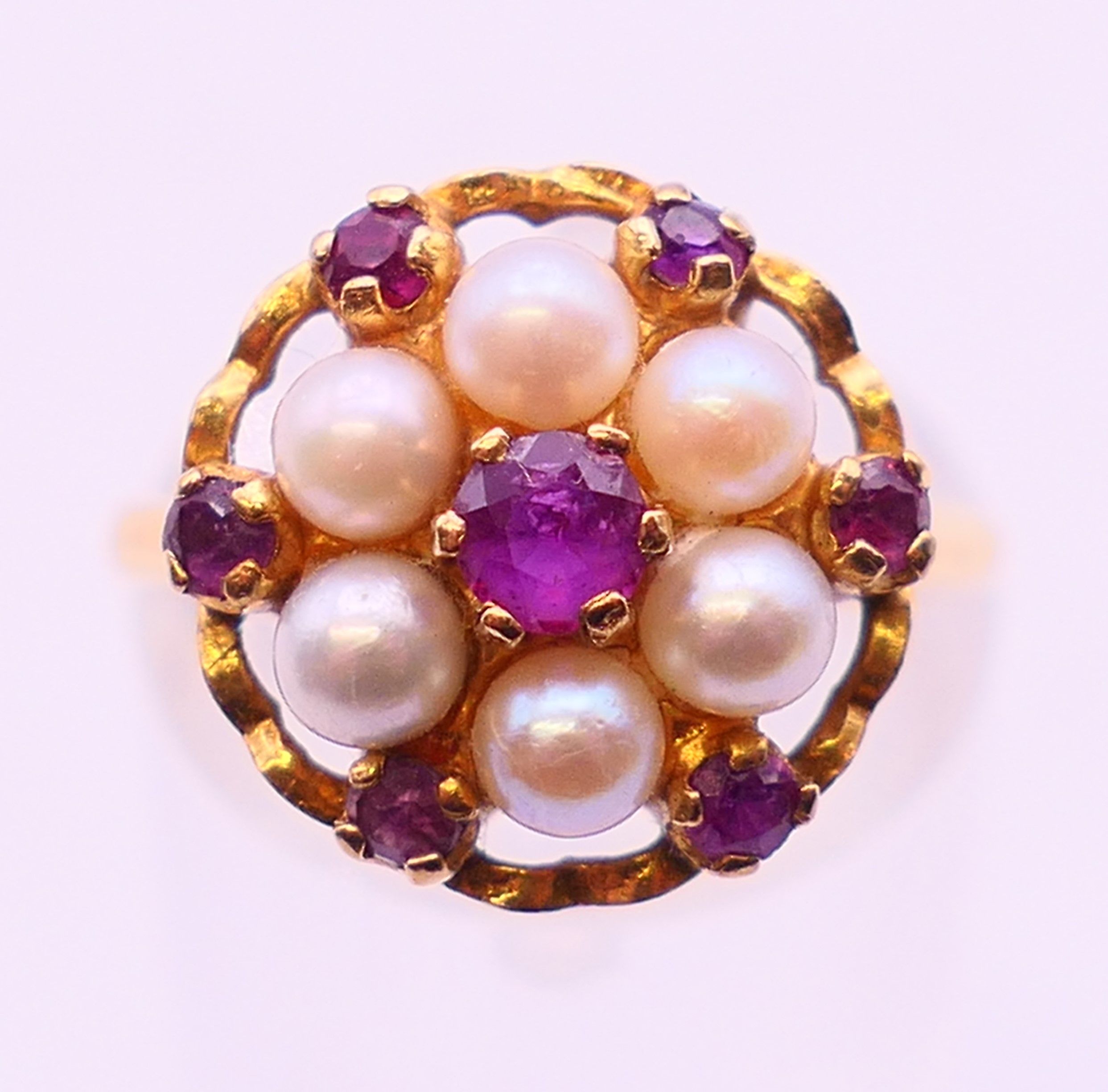 A 9 ct gold, pearl and ruby cluster ring. Ring size M.