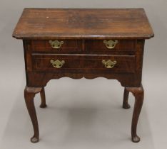 A Georgian walnut lowboy. 77 cm wide.