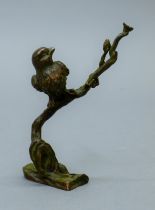 A bronze model of a bird in a tree. 10 cm high.