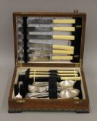 An oak-cased silver-plated cutlery canteen. 29.5 cm wide.