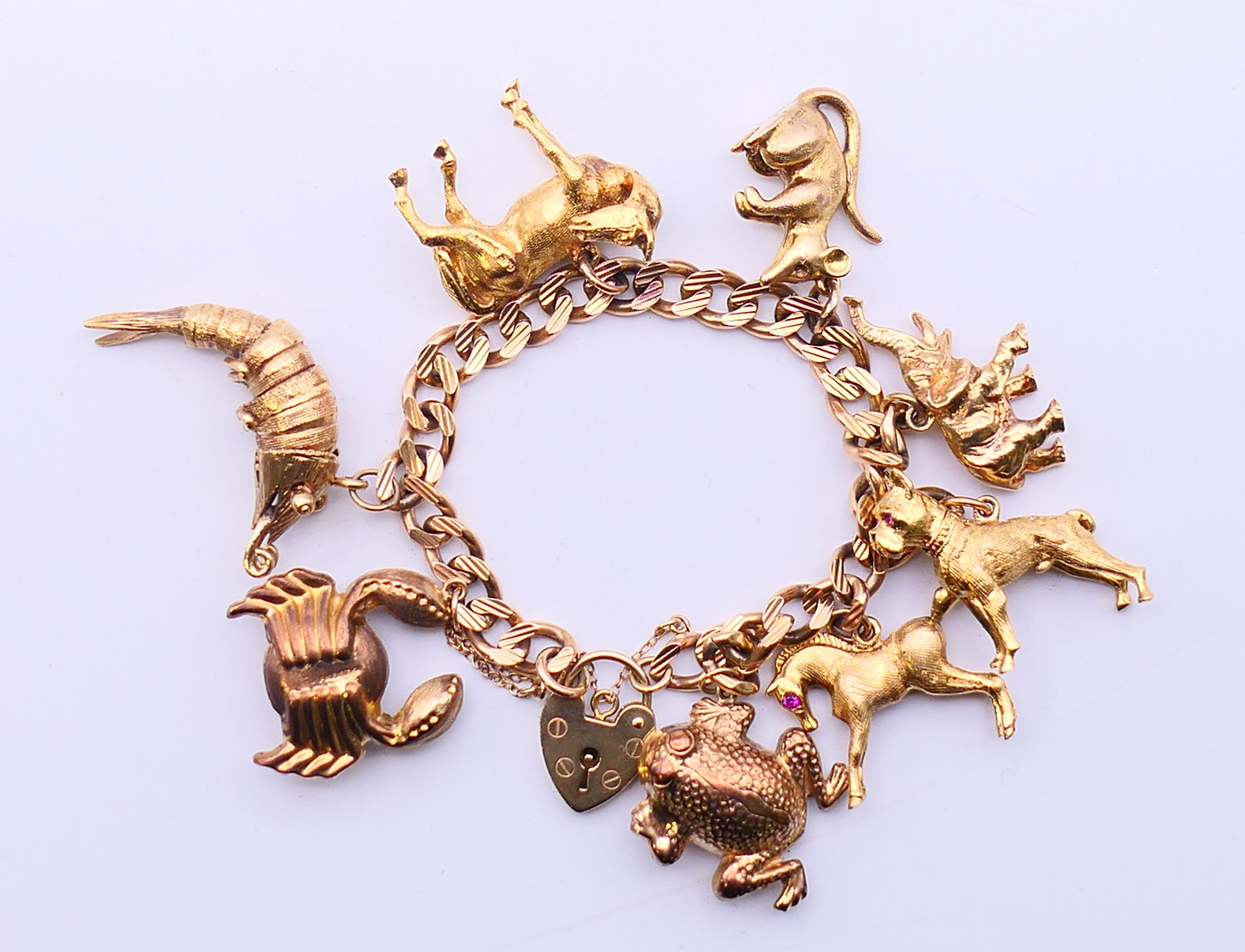 A 9 ct gold curb link bracelet with eight animal charms. 18 cm long. 60. - Image 2 of 5