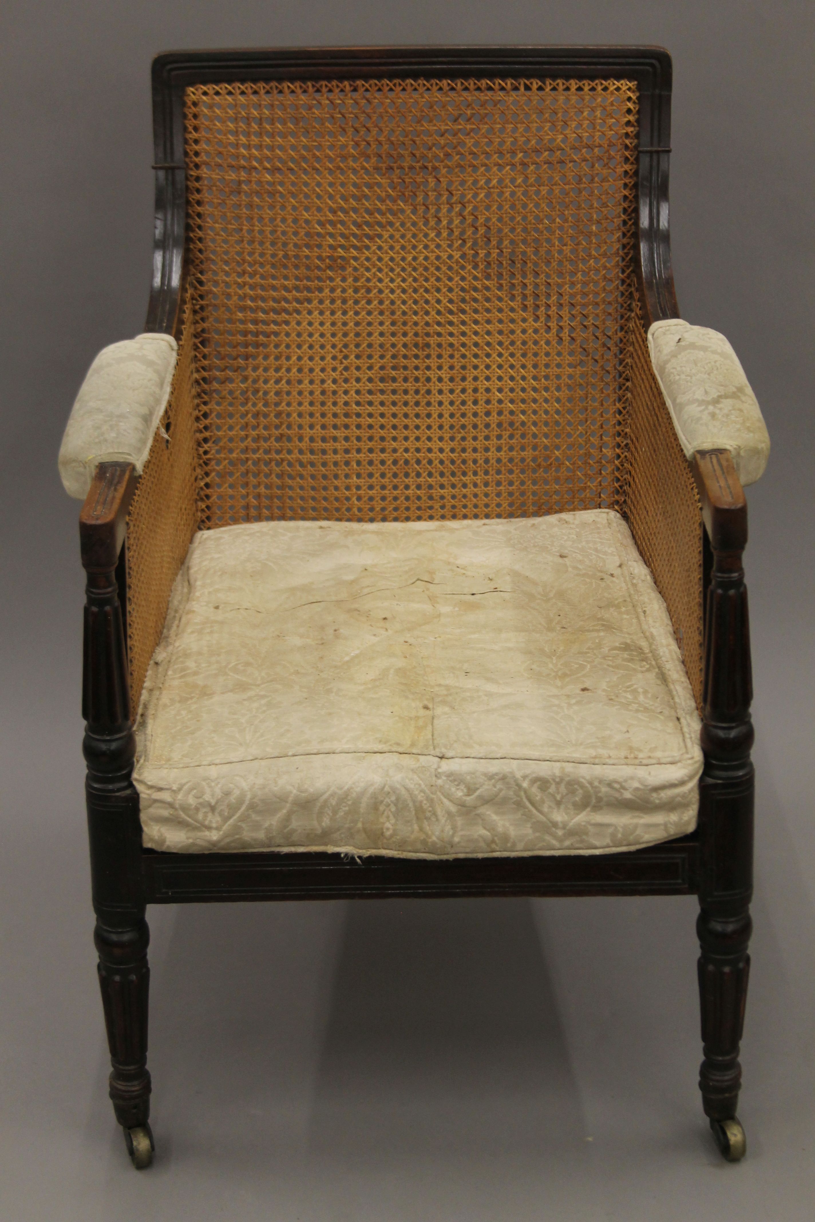 A 19th century mahogany bergere chair. 65 cm wide.