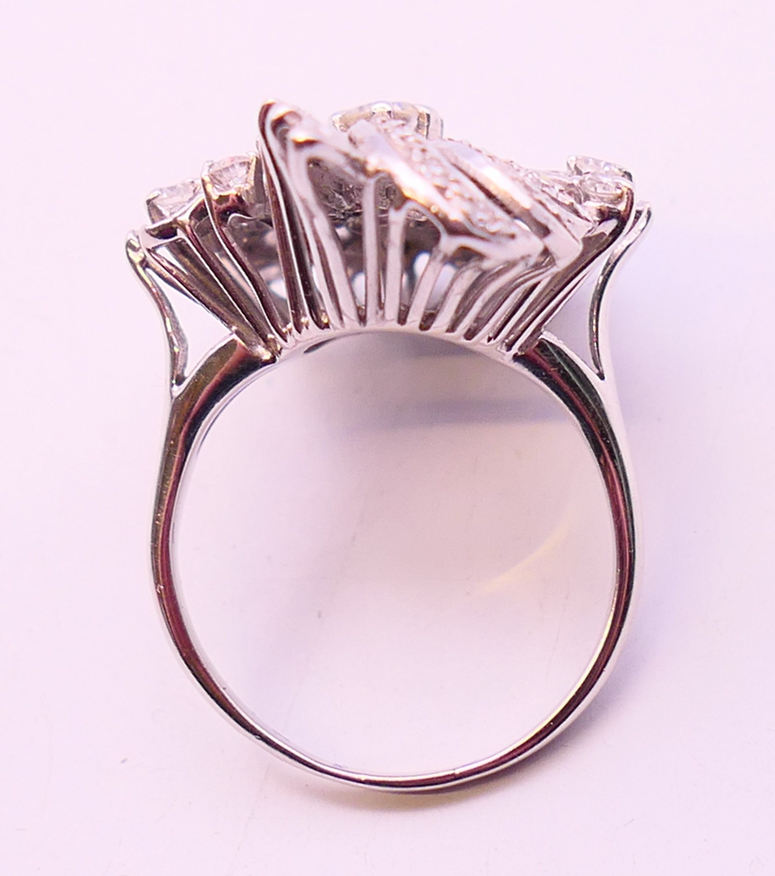 An unmarked platinum or white gold, diamond floral spray ring. 3cms long. Ring size Q/R. - Image 6 of 6