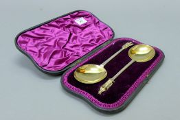 A pair of silver and silver gilt apostle spoons, hallmarked for London 1890, boxed. Each 21 cm long.