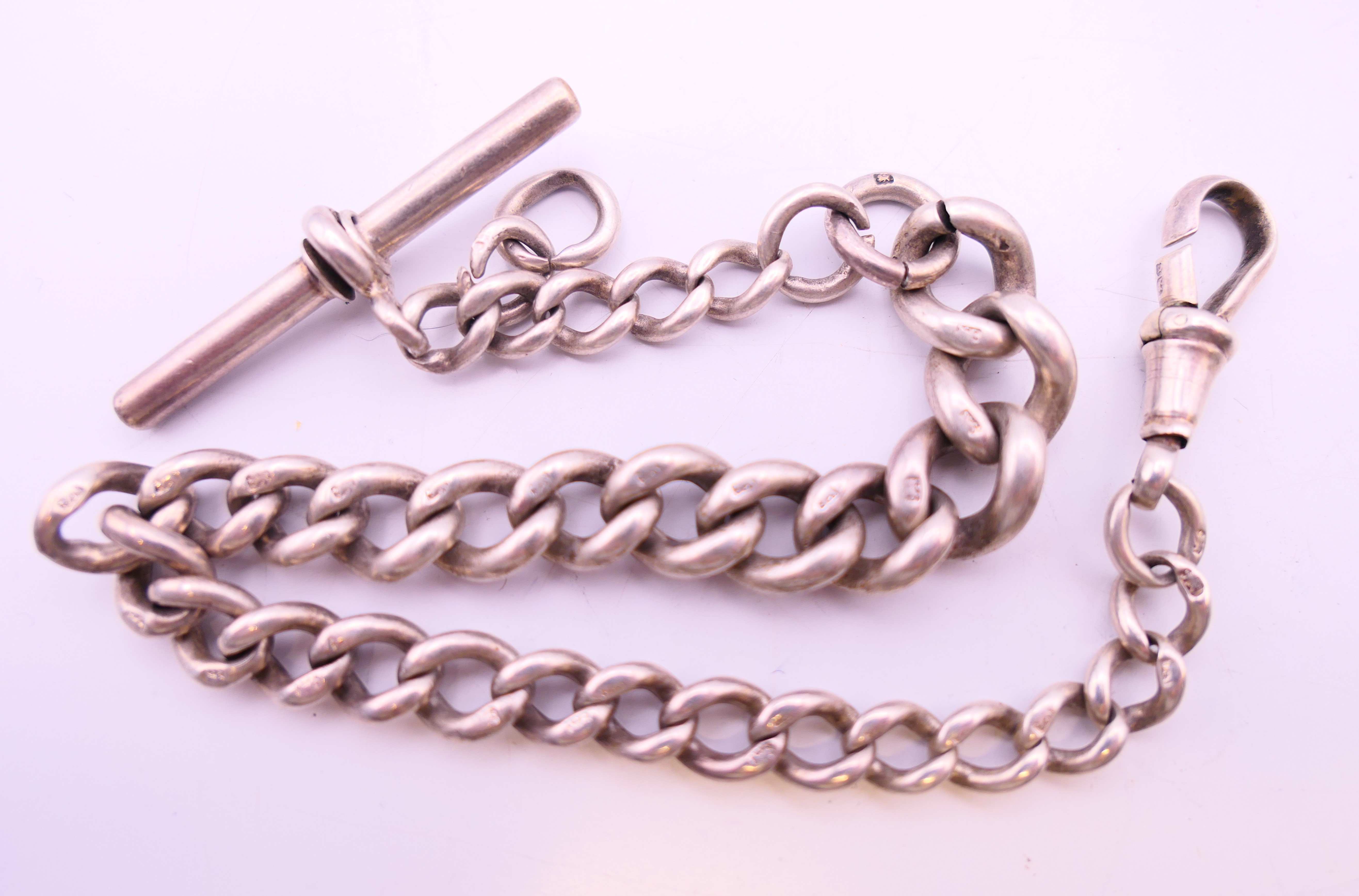 A silver ingot, an identity bracelet and a watch chain. Ingot 4 cm high. 130.1 grammes. - Bild 4 aus 8