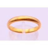 A 22 ct gold band ring, hallmarked gold 22 ct, 1926. 3.3mm width. Ring size P. 5.1 grammes.