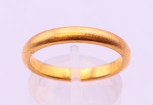 A 22 ct gold band ring, hallmarked gold 22 ct, 1926. 3.3mm width. Ring size P. 5.1 grammes.