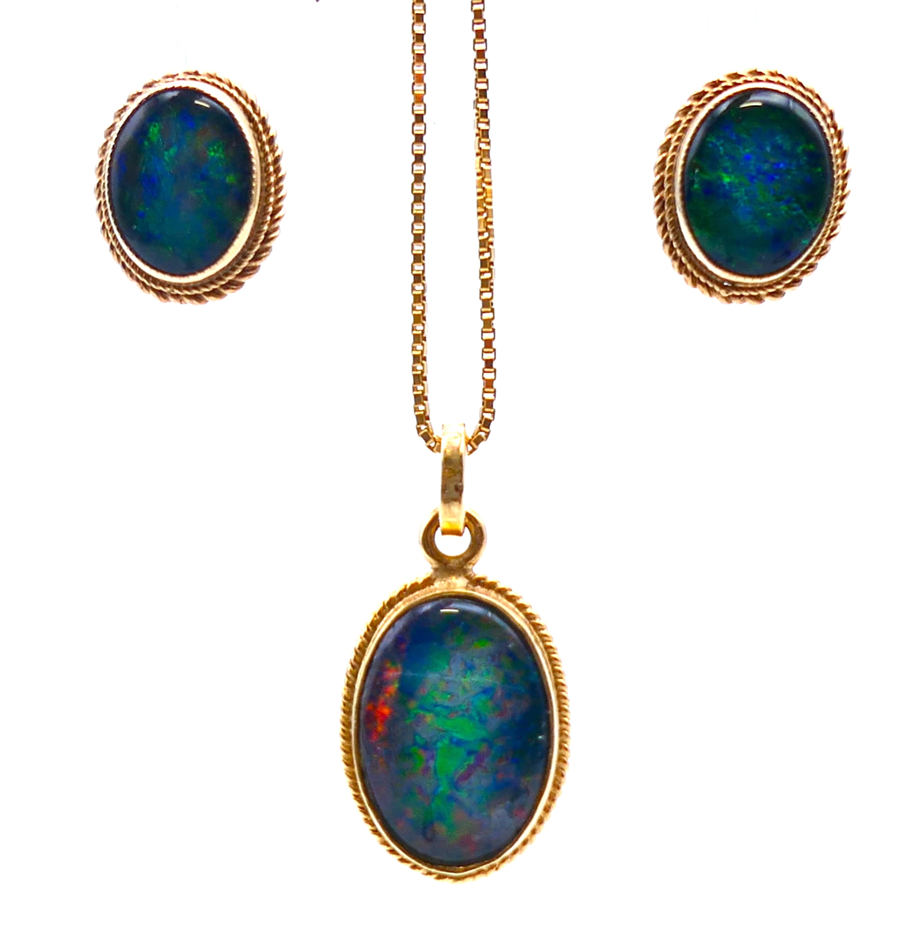 An opal and gold pendant on an 18 ct gold chain and a pair of 9 ct gold matching earrings.