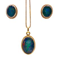 An opal and gold pendant on an 18 ct gold chain and a pair of 9 ct gold matching earrings.