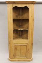 A pine corner cupboard. 92 cm wide, 195 cm high.