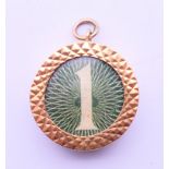 A 9 ct gold £1 note charm. 2 cm diameter.