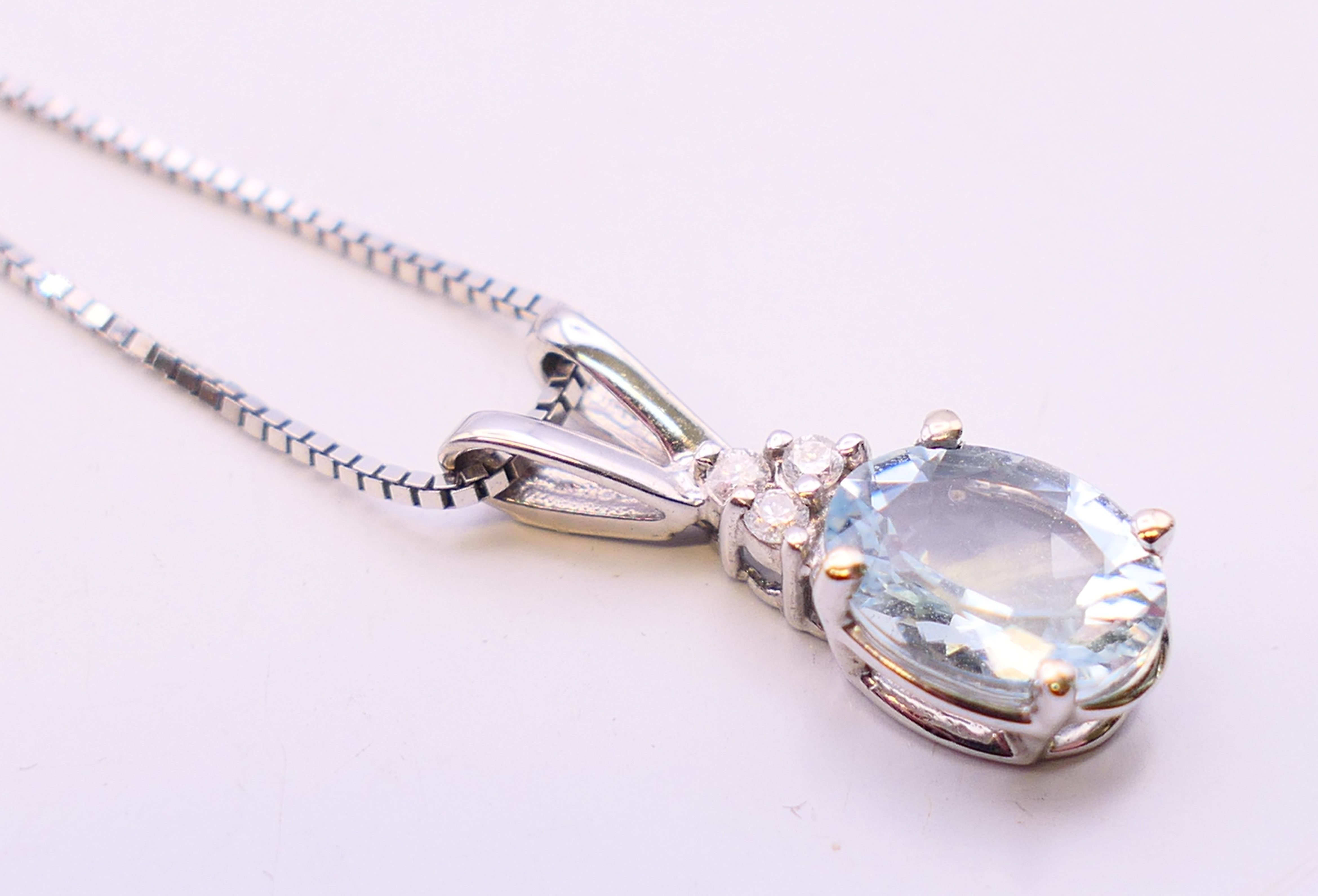 A 14 ct white gold aquamarine diamond pendant on a 14 K white gold chain. - Image 3 of 7