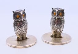Two Sampson Mordan and Co silver owl form menu holders on circular bases. 3 cm high.