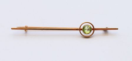 A 9 ct gold circular peridot bar brooch. Peridot 5.3mm, brooch 6.5 cm long. 3.