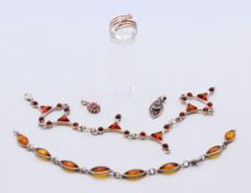 A collection of silver jewellery, including amber and pendants.