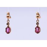 A pair of 9 ct gold oval pink gem earrings (believed to be tourmaline) with brilliant cut diamond.