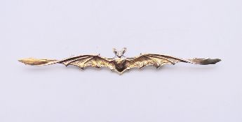 A silver brooch in the form of a bat. 12 cm long.