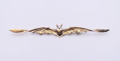 A silver brooch in the form of a bat. 12 cm long.