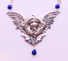 A silver Art Nouveau-style pendant necklace.