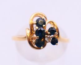 A Continental 14 ct gold diamond and sapphire abstract ring. Ring size Q.