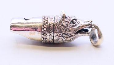 A silver whistle pendant in the form of a fox head. 4 cm high.