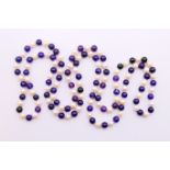 A string of amethyst and pearl beads. 122 cm high.