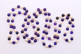 A string of amethyst and pearl beads. 122 cm high.