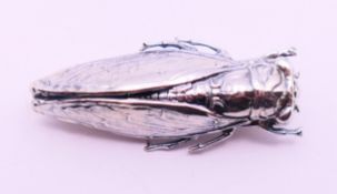 A silver brooch in the form of a beetle. 5 cm long.