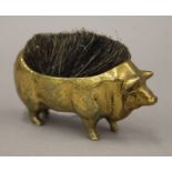 A brass pen wipe formed as a pig. 11 cm long.