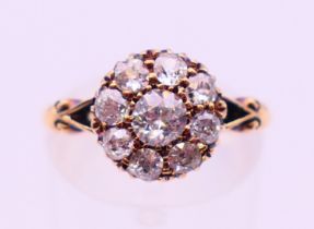 An 18 ct gold and diamond cluster ring. Ring size L.