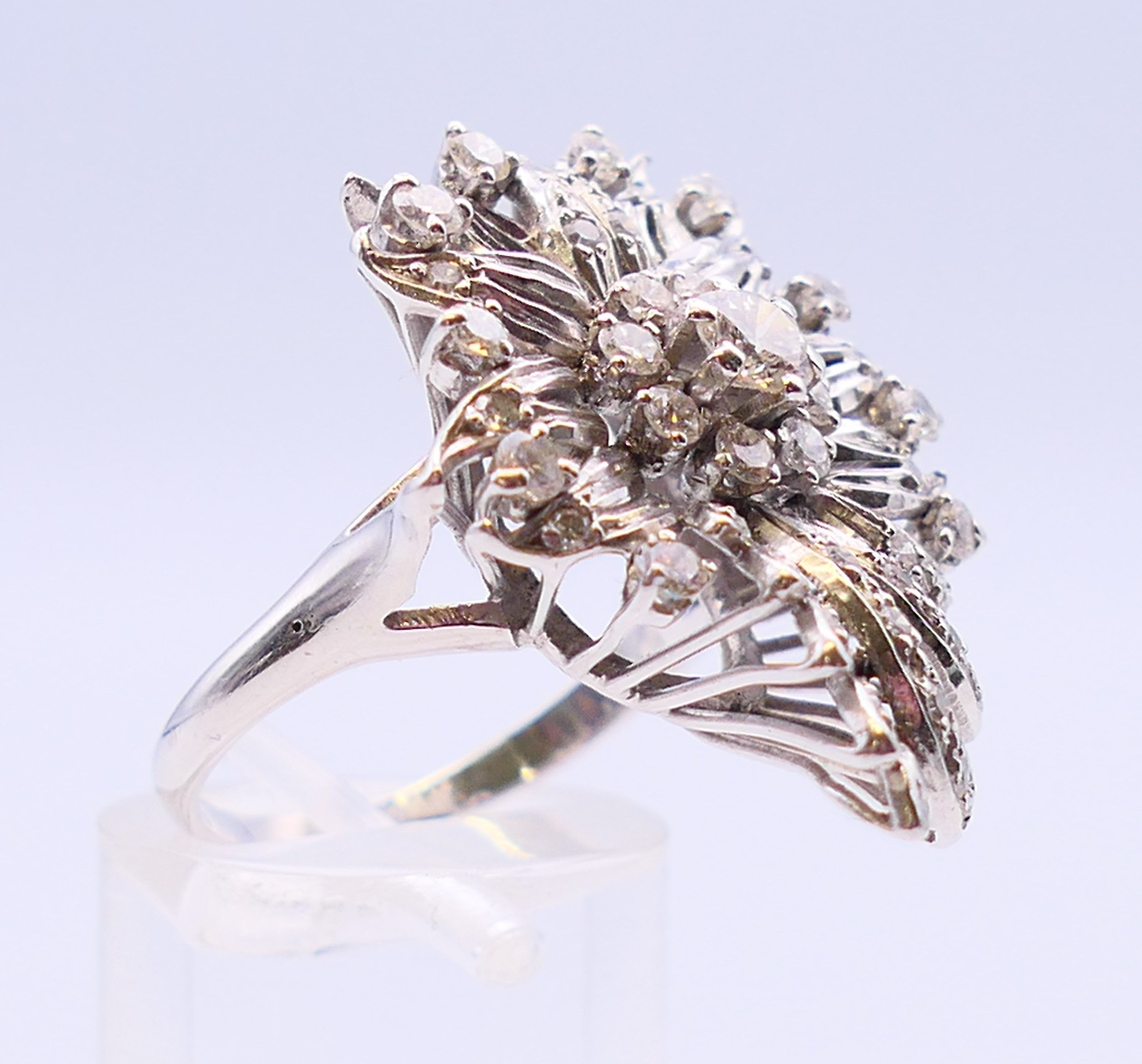 An unmarked platinum or white gold, diamond floral spray ring. 3cms long. Ring size Q/R. - Image 3 of 6