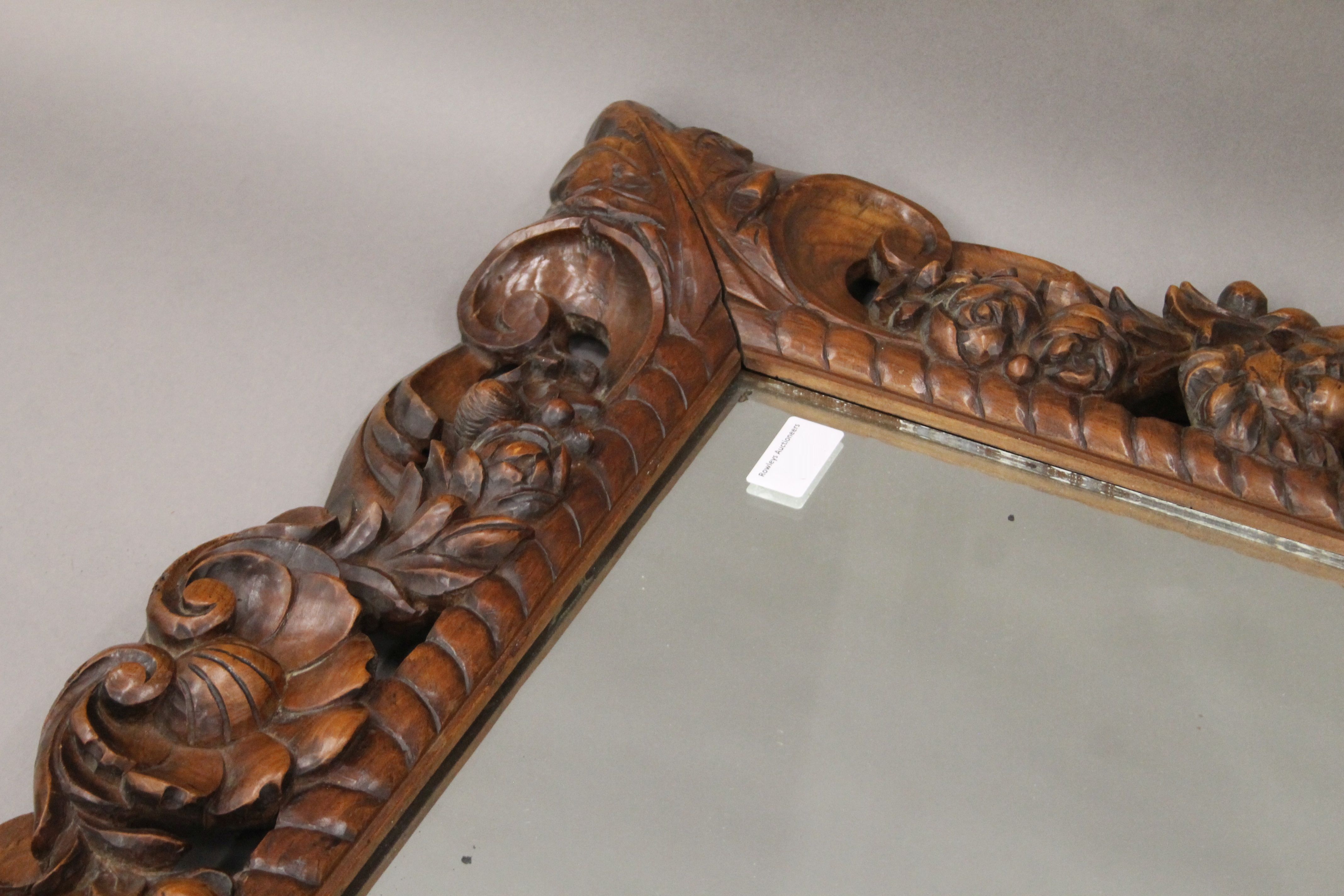 A 19th century carved walnut wall mirror decorated with putti, flowers, fruit and scroll work. - Image 2 of 3