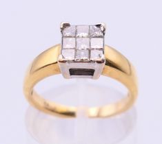 An 18 ct gold ring set with nine diamonds. together with a copy of a 2012 insurance valuation.
