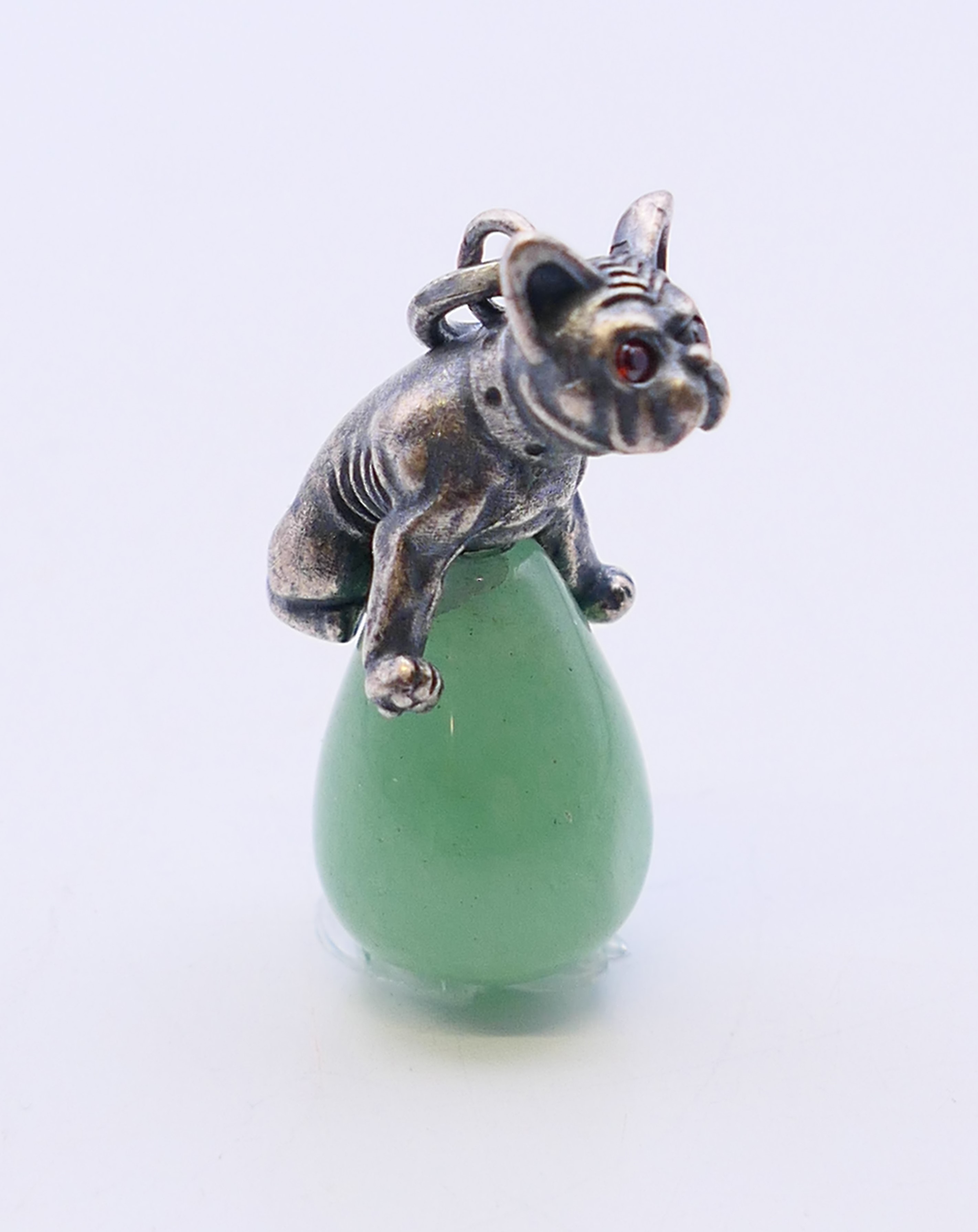 A jade pendant in the form of a dog astride an egg, bearing Russian marks. 3 cm high. - Image 2 of 4