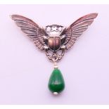 A silver and jade brooch in the form of a winged scarab beetle. 5 cm high x 5.5 cm wide.