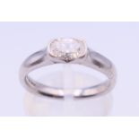 A platinum and diamond solitaire ring. Ring size M.