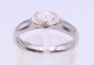 A platinum and diamond solitaire ring. Ring size M.