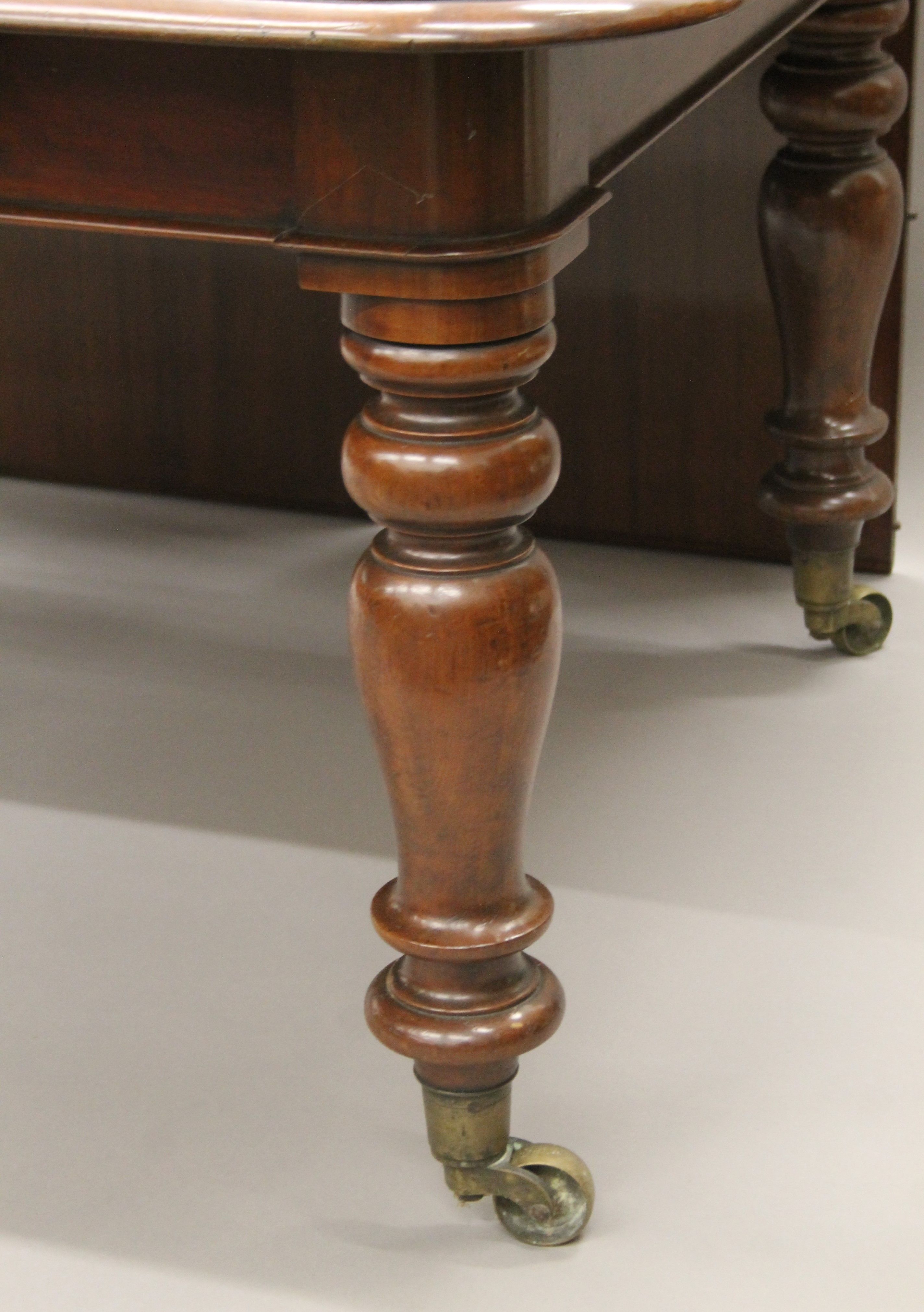 A 19th century mahogany three-leaf extending dining table. - Image 4 of 5