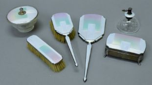 An Art Deco cased enamel decorated silver dressing table set, cased. The case 40 cm wide.