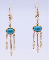 A pair of turquoise and freshwater pearl ear pendants, stamped 585, oval turquoise 7.8 x 5.